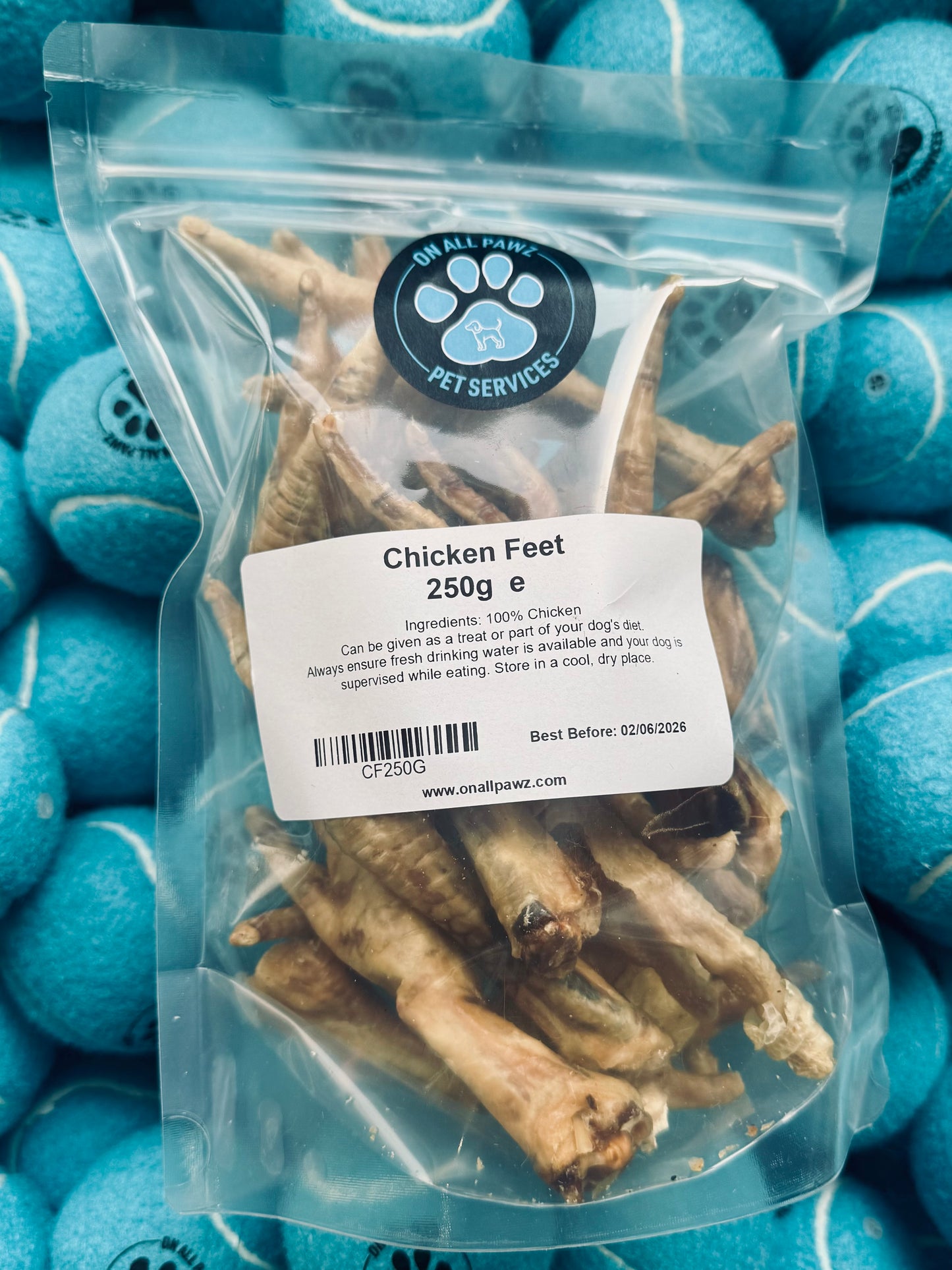 Package of chicken feet with a label on blue tennis balls