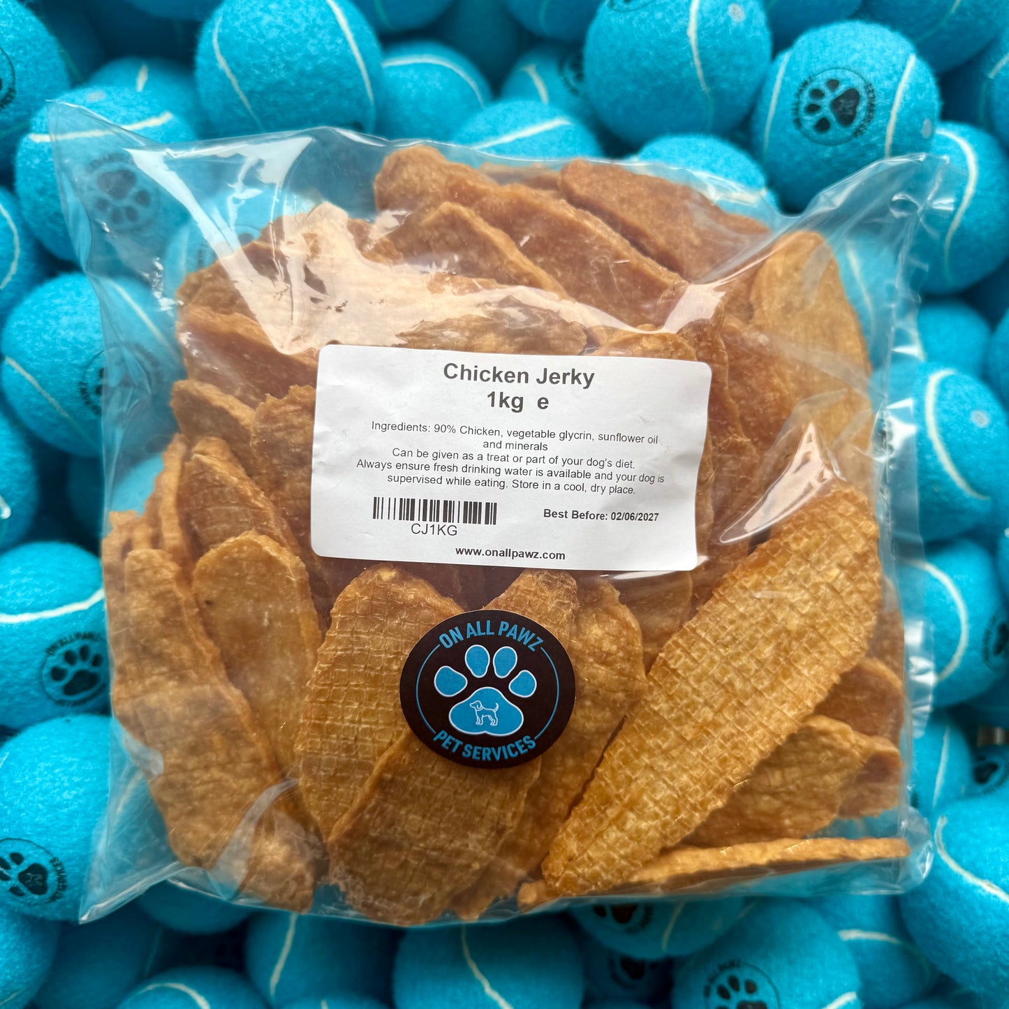 Bag of chicken jerky with a label on blue tennis balls