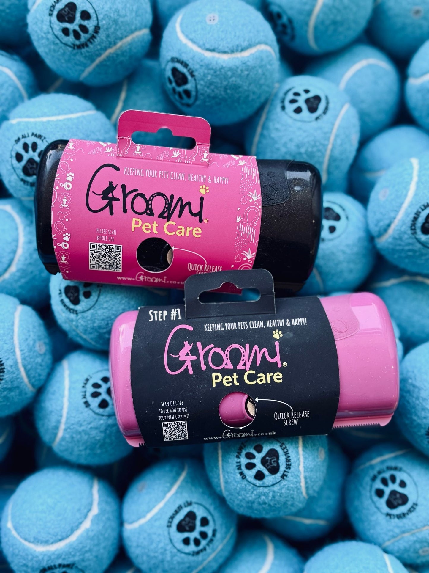 Groomi Pet Care products on a background of blue tennis balls with paw prints.
