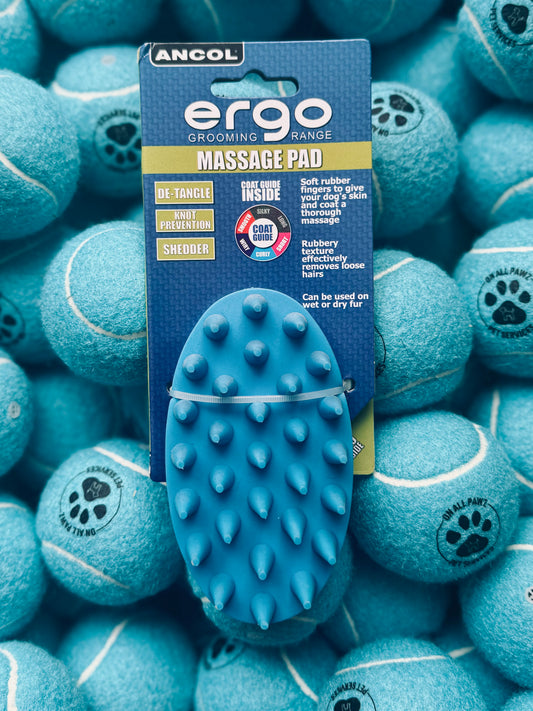 A blue Ergo Massage Pad for pets displayed in packaging, surrounded by blue tennis balls.