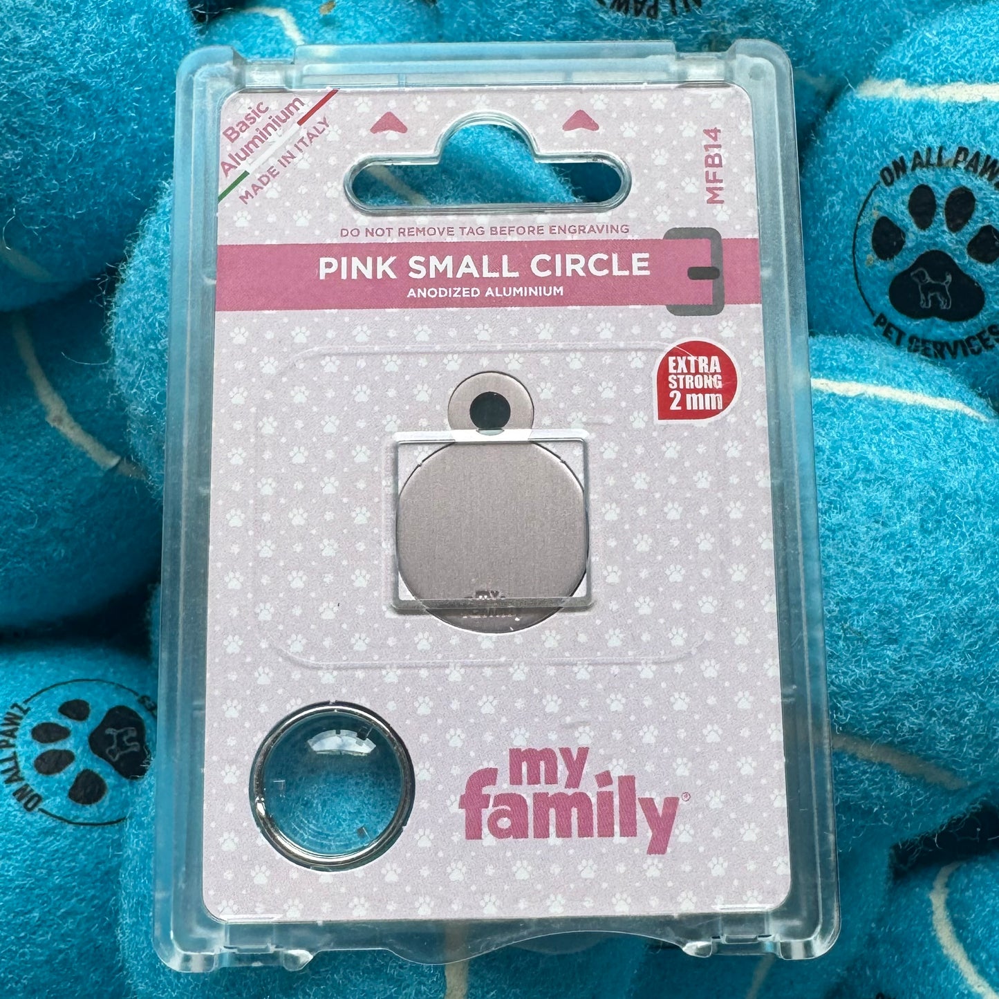Metallic pink small circle on packaging with 'my family' branding against a blue textured background.