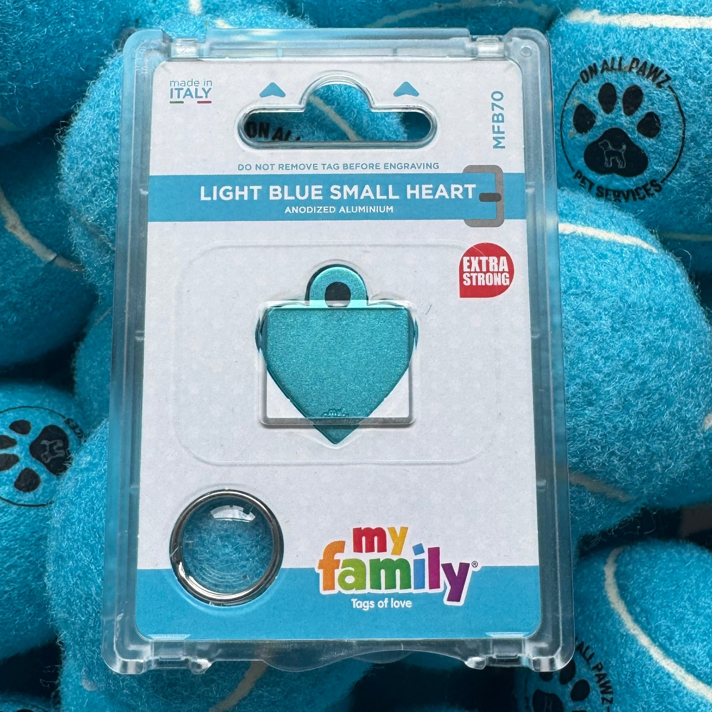 Light blue heart-shaped tag in packaging with 'my family' branding on a blue background.