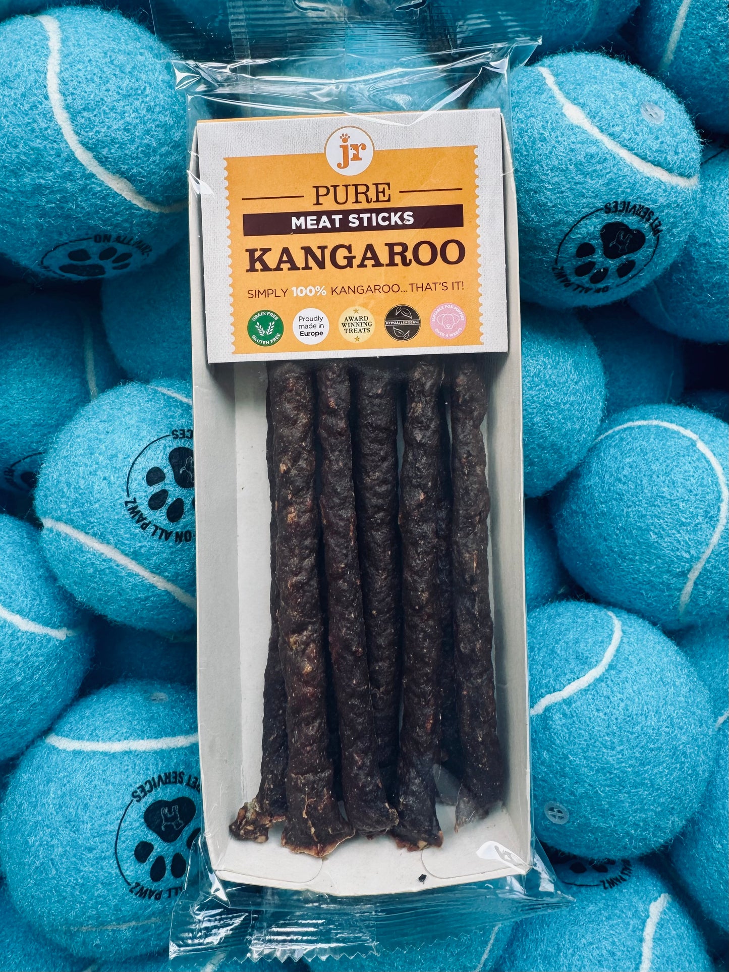 Pack of Pure Meat Sticks Kangaroo with blue tennis balls in the background