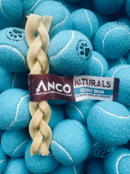 Dog toy with coconut braid on a background of blue tennis balls, featuring the Anco Naturals brand.
