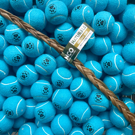 Blue tennis balls with paw prints and a brown rope on a blue background