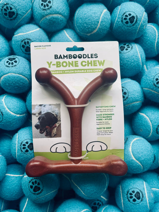 Bamboodles Y-Bone Chew toy packaging surrounded by blue tennis balls