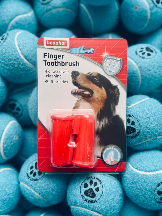 Packaging of Beaphar Finger Toothbrush with two soft bristled brushes visible, displayed against a background of pet treats.