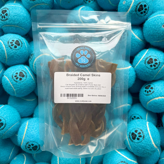 Packaged dog treat with blue balls in the background
