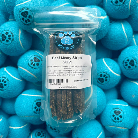 Packaged beef meaty strips with a label on a background of blue tennis balls.