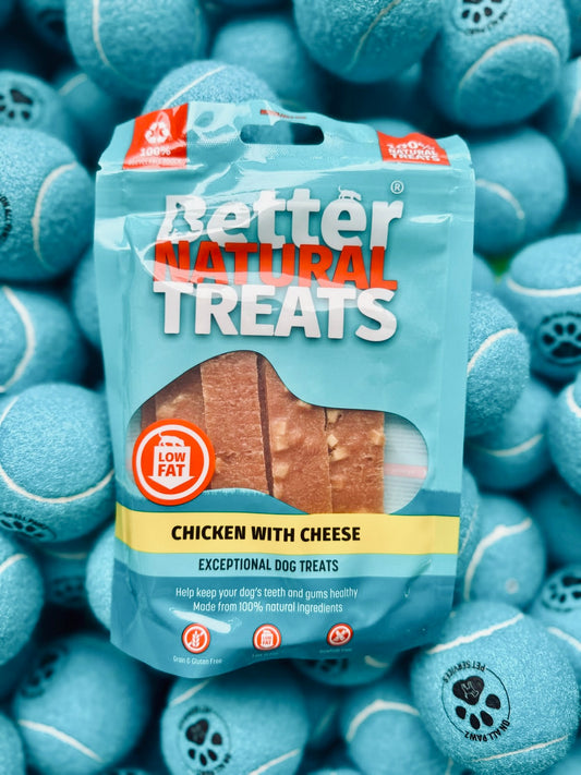 Package of Better Natural Treats chicken with cheese dog treats surrounded by blue tennis balls.