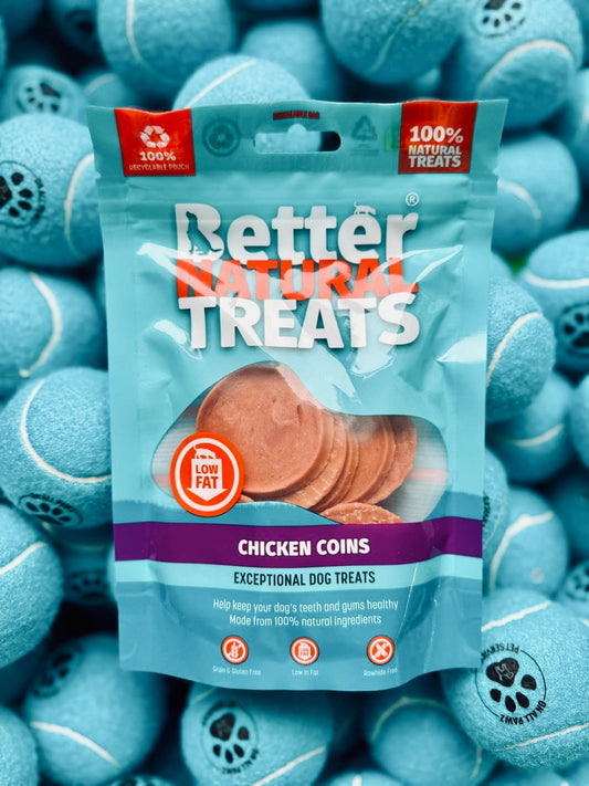 Package of Better Natural Treats Chicken Coins with blue tennis balls in the background