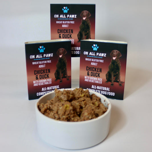 Dog food in a bowl with 'On All Pawz' packaging in the background