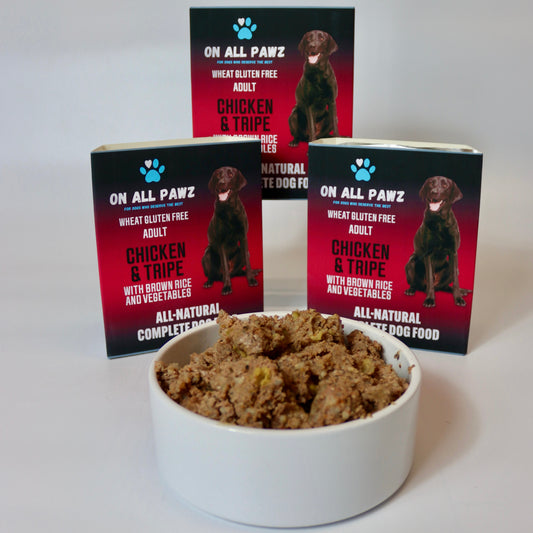 Dog food in a bowl with 'On All Pawz' packaging in the background