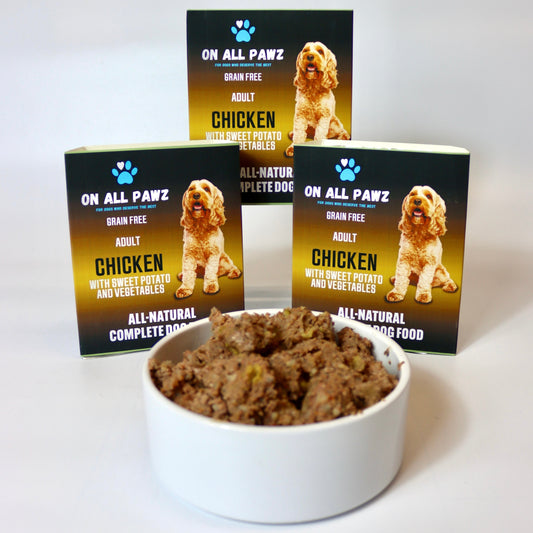 Bowl of dog food with 'On All Pawz' packaging in the background