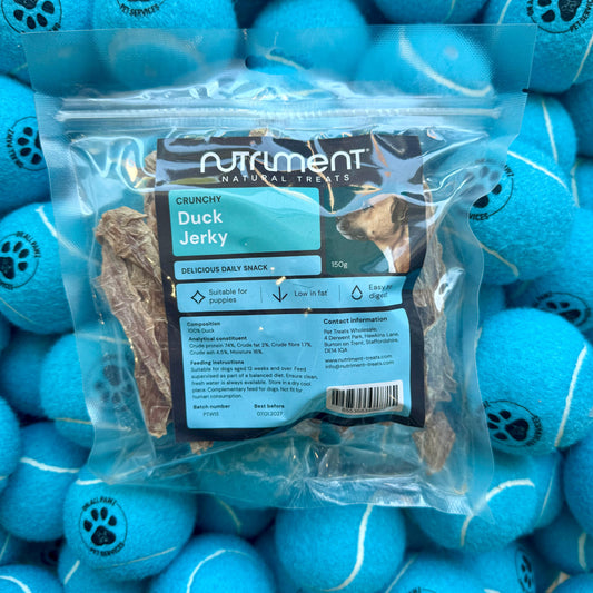 Package of Nutriment Duck Jerky surrounded by blue tennis balls