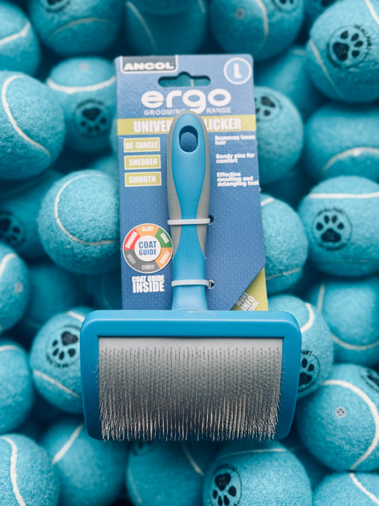 An Ancol Ergo Slicker Brush Large in blue color, displayed on a background of blue tennis balls.