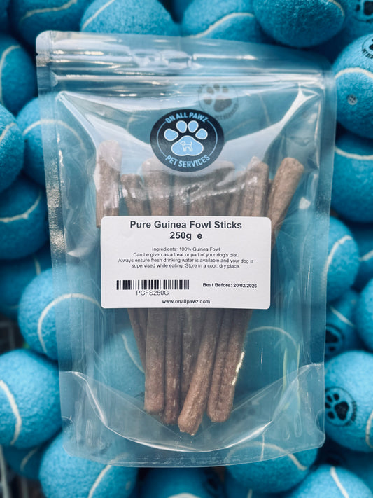 Packaging of Pure Guinea Fowl Sticks 250g for dogs, displaying the product through a clear plastic bag.