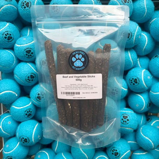 Package of beef and vegetable sticks with blue tennis balls in the background