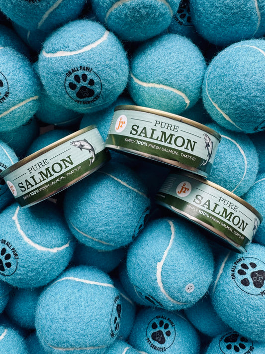 Blue tennis balls with 'Pure Salmon' cans on top