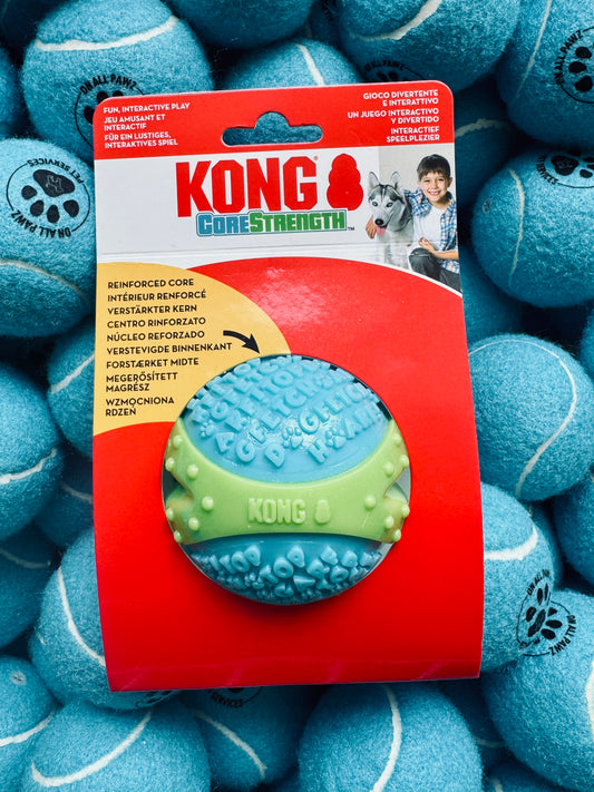 Kong Core Strength toy packaging surrounded by blue tennis balls