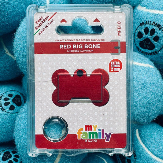 Red dog bone-shaped ID tag in packaging with 'my family' branding on a blue plush toy background.