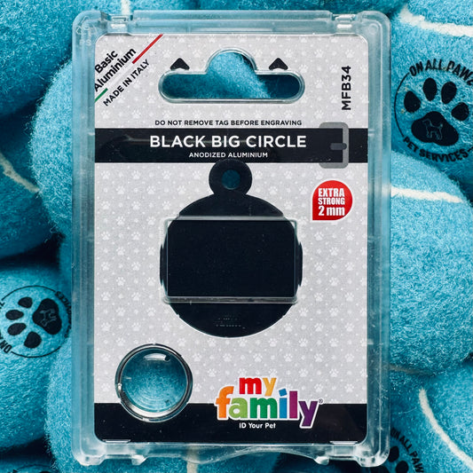 Black pet ID tag in packaging with blue paw prints in the background