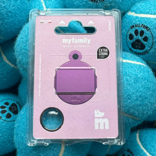 Purple pet tag in clear packaging on a blue plush background with paw prints.