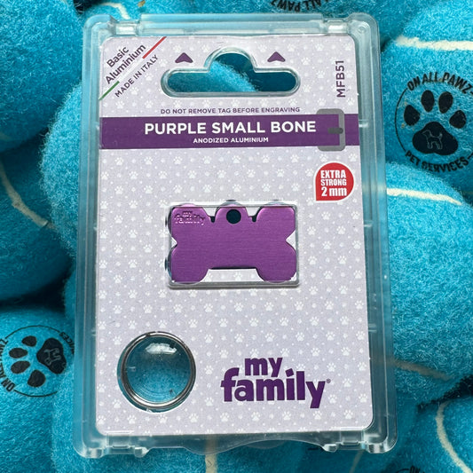 Purple dog tag packaging with 'my family' branding on a blue plush toy background