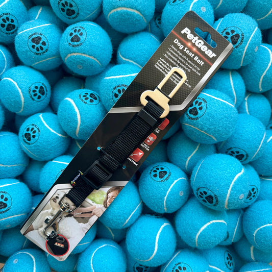 PetGear dog seat belt packaging on a pile of blue tennis balls