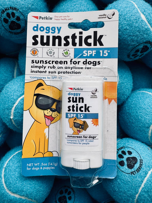 Petkin doggy sun stick sunscreen for dogs on a blue background with tennis balls.