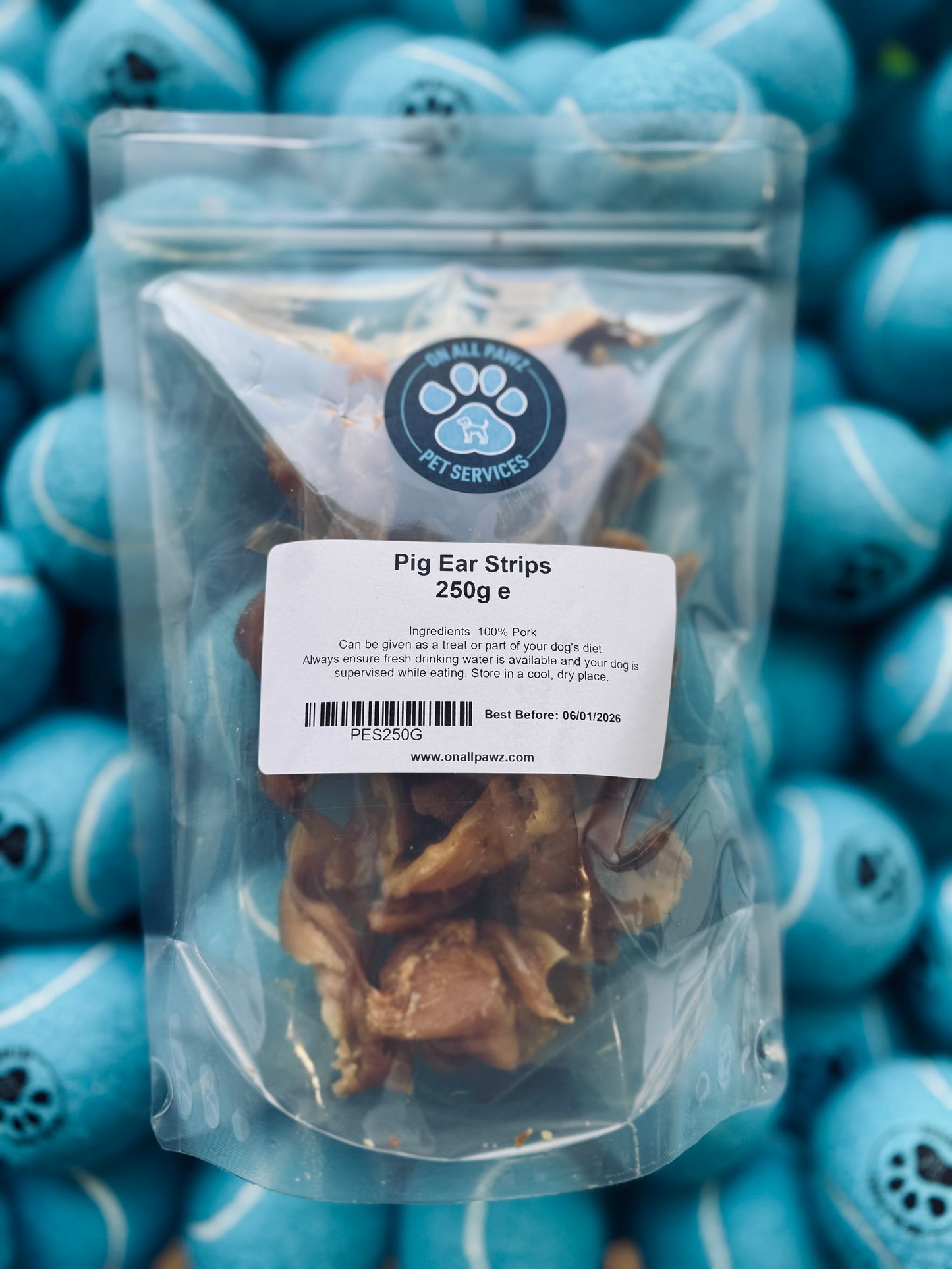 Packaged Pig Ear Strips in a clear plastic bag, with product information and branding visible.