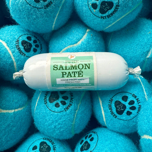Salmon pate package surrounded by blue tennis balls with pet service logos.