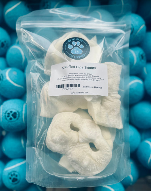 Packaged dog treats with a label on a background of blue balls