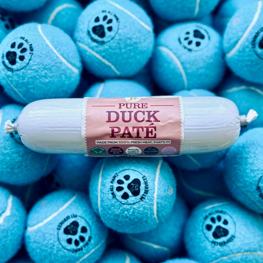 Roll of Pure Duck Páté on blue tennis ball treats with paw prints