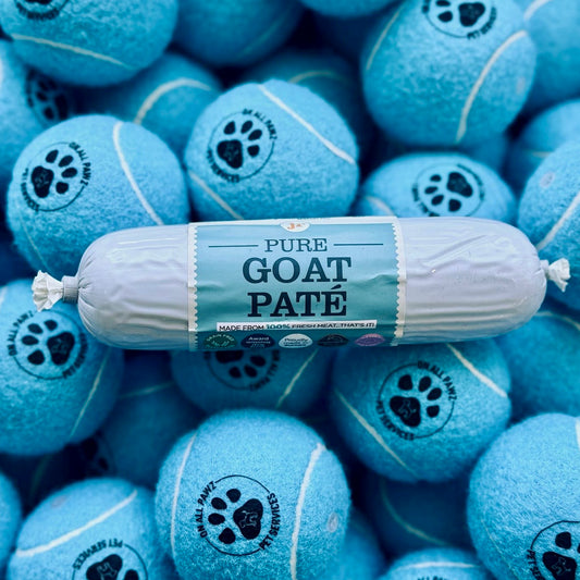 Roll of Pure Goat Pate with blue tennis ball-shaped treats in the background