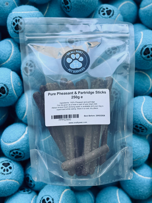 A clear plastic packaging containing air-dried pheasant and partridge sticks for dogs, with a label stating 'Pure Pheasant & Partridge Sticks 250g'.