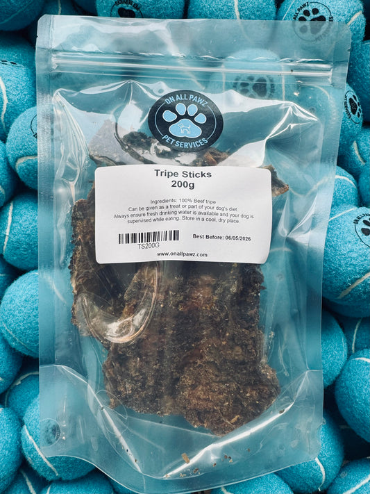 Package of Tripe Sticks for dogs with a label on a background of blue dog toys.