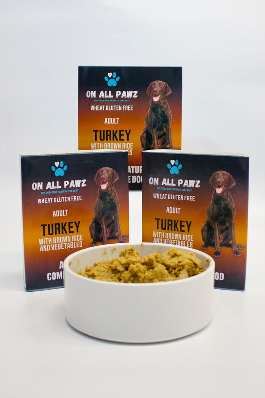Dog food bowl with a package of On All Pawz turkey dog food on a white background