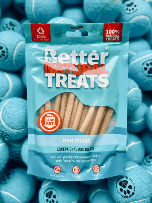 Package of Better Natural Treats Fish Sticks with tennis balls in the background
