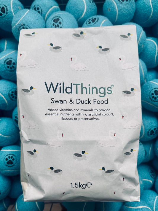 Package of Wild Things Swan & Duck Food surrounded by blue spherical objects